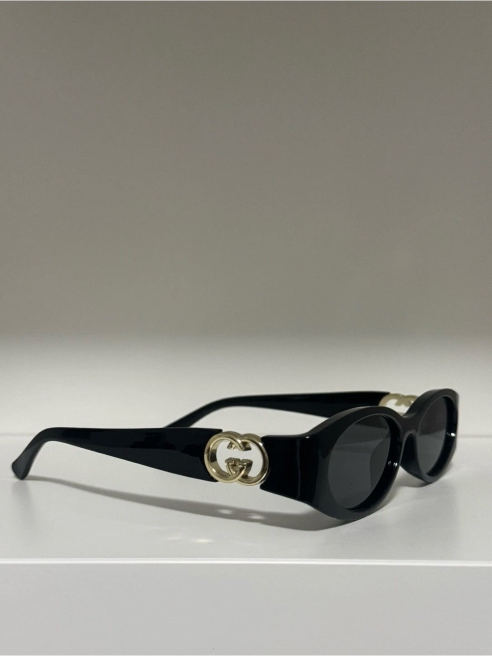 Black Oval Sunglasses with Gold Interlocking G
